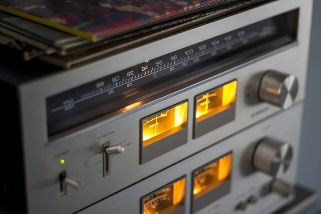 Stereo receiver and amplifier stack with glowing VU meters