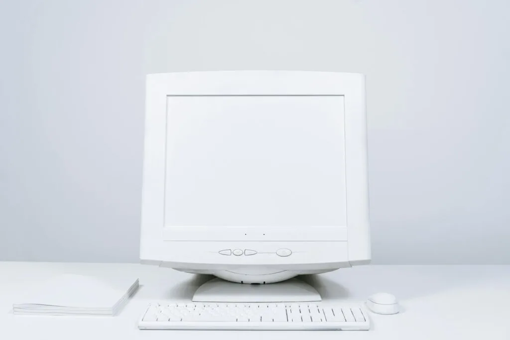 Clean computer monitor on a desk — checking for a bug behind the screen